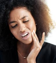 Woman experiencing jaw pain